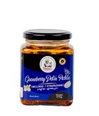 Jar of gooseberry dates pickle with blue label on a white background