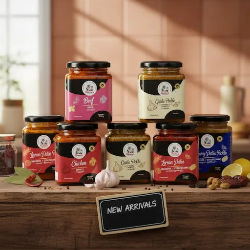 Assorted jars of pickles on a wooden surface with a 'New Arrivals' sign.