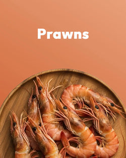Wooden plate with prawns on a brown background