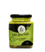 Jar of white lemon pickle with green label on a white background