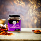 Jar of Prawn Chatney Powder with a purple label on a wooden surface.
